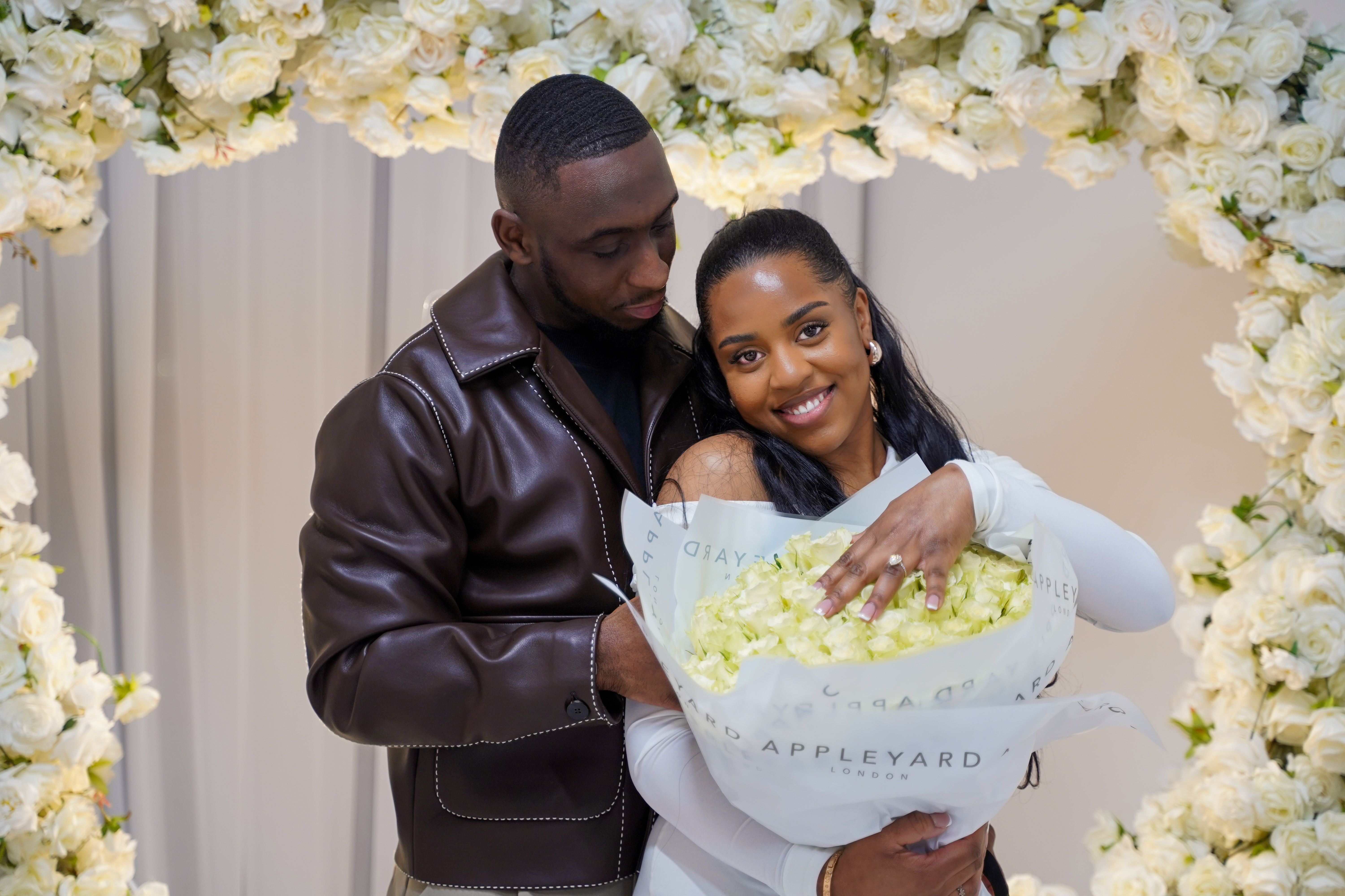 Couple smiling together at an engagement celebration